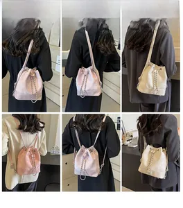 Detail view of the soft PU leather bucket bag with metallic chain and drawstring closure
