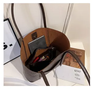 Macro view showing large capacity interior of brown crocodile pattern tote bag with inner pouch