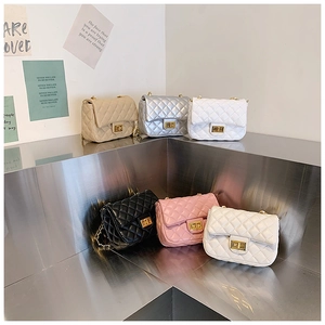 Close-up of quilted mini bags with gold ball chain in beige, silver, white, black and pink