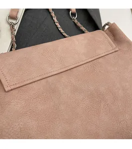 Close-up of precise stitching and premium leather texture on a pink chain shoulder bag