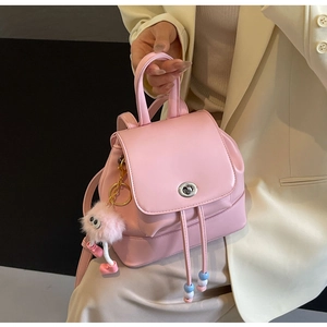 Mini zaino rosa con chiusura a rotazione argento e ciondolo a pompon in peluche rosa