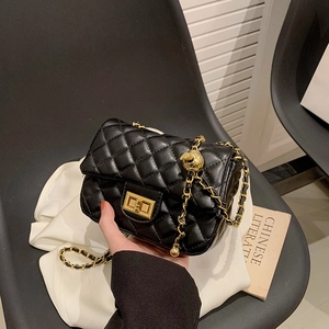 Classic black quilted leather crossbody bag with gold chain and adjustable gold ball