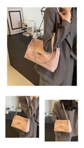 Detail of soft pink lychee pattern leather tote bag with stylish gold chain strap and metal plate