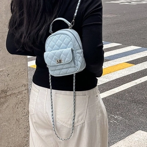 Chic light blue quilted mini backpack with metal chain strap and top handle for women
