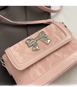 Detailed view of pink crossbody bag with marble texture and silver butterfly buckle