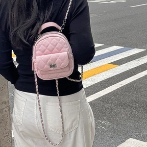 Pink quilted leather mini backpack for women featuring a metal chain strap and top handle