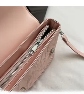 Detail of pink marble pattern handbag showing smooth silver zipper and magnetic buckle