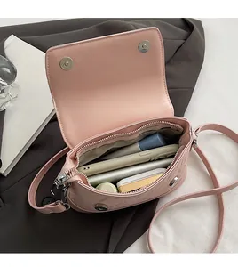 Interior view of pink PU leather bucket bag showing magnetic clasp and zip pocket storage