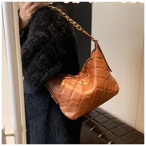 Brown quilted hobo bag featuring golden chain strap and floral ornament detail