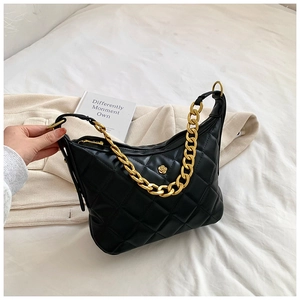 Close-up of black quilted hobo bag featuring a gold floral logo and chunky metal chain