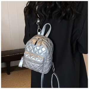 Silver quilted mini backpack detail showing metallic finish and diamond stitching style