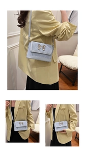 Three-angle views of a light blue marble-textured bucket bag with a butterfly lock
