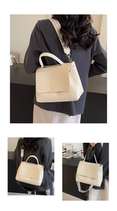 Detail der cremefarbenen Trapez-Handtasche mit gewebtem Riemen und goldener Schnalle