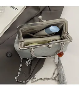 Detail view of the spacious inner compartment of this silk embroidery kiss-lock bag