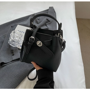 Detail der schwarzen Bucket Bag aus Leder mit Litschimuster und silbernem Drehverschluss