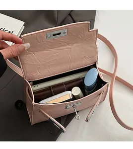 Internal view showing storage capacity of pink embossed leather handbag with silver lock