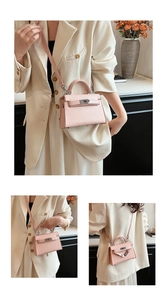 Detail of pink pleated leather mini handbag with silver twist lock and bottom studs
