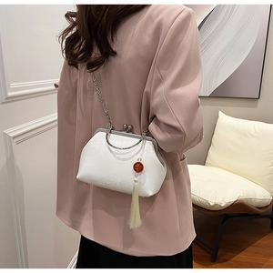 Elegant white satin clutch bag with gold frame, chain strap and amber tassel detail