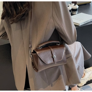 Dark brown matte leather handbag styled as a crossbody bag for professional commuting