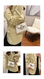 Detailed views of a beige leather handbag with silver rotary lock and top handle