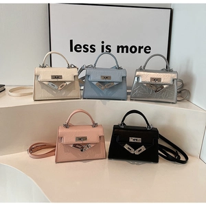 Detail view of mini textured leather handbags in five colors with metallic turn-lock closure
