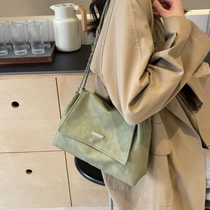 Sage green leather tote bag with silver chain strap and minimalist shoulder design