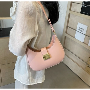 Détail du sac sous le bras en forme de croissant rose avec boucle en métal doré chic