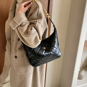French style black quilted shoulder bag with gold floral buckle and chain strap