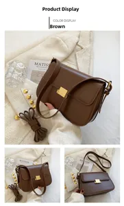 Detail view of brown leather crossbody bag with a polished gold square metal buckle