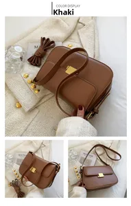 Detail view of khaki crossbody bag with a gold square clasp and smooth matte leather