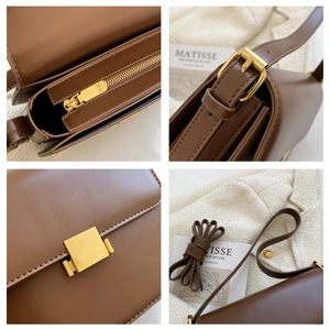 Detail view of brown vintage crossbody bag with gold buckle and adjustable strap