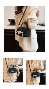 Detailed views of a black wavy texture handbag with pearl bow charm and shoulder strap