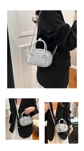 Detailed view of silver velvet crossbody bag with marble texture and heart hardware