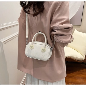 Mini white velvet-texture bag with yellow heart accents on pink suit outfit