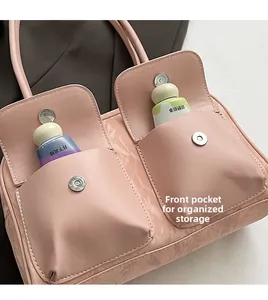 Detailed macro view of pink PU leather handbag with dual magnetic front pockets and marble texture