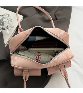 Pink baguette bag showing interior capacity for phone, umbrella, and daily essentials