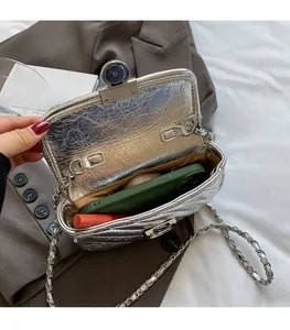 Interior view of silver quilted chain bag showing space for phone and lipstick