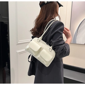 Glossy white faux leather shoulder bag with dual front flap pockets and slim straps