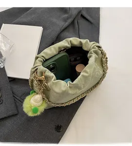Interior view of mint green pleated bucket bag showing storage for phone and cosmetics