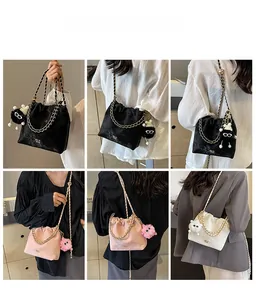 Detail view of velvet bucket bags with metal chain straps and cute plush charms