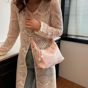 Detail of pink silk brocade jacquard bag with traditional Chinese garden pattern and bead