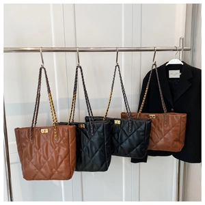 Quilted tote bags with gold metal clasps and chain straps in black and brown finishes