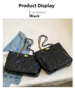 Detailed view of black quilted tote bags with gold twist locks and chain straps