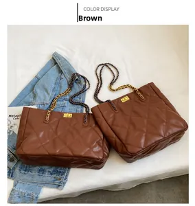 Detail of brown quilted tote bags with gold twist locks and leather chain straps