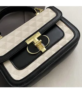 Detail of premium beige geometric embossed flap with elegant golden T-shaped metal lock