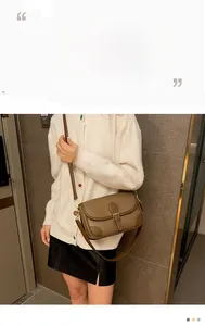 Brown lychee leather shoulder bag styled on a model for a chic urban fashion look