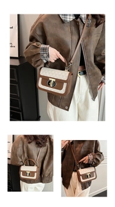 Close-up of geometric pattern, leather trim and gold oval metal lock on crossbody bag