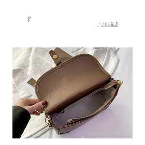 Detailed view of the large capacity interior of this brown leather shoulder bag with zipper pocket