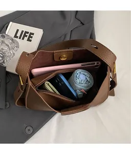 Interior view of brown lychee leather bucket bag showing spacious storage and items