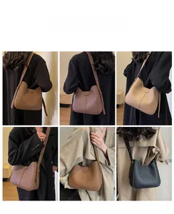 Litchi pattern leather bucket bag detail showing adjustable strap and large capacity
